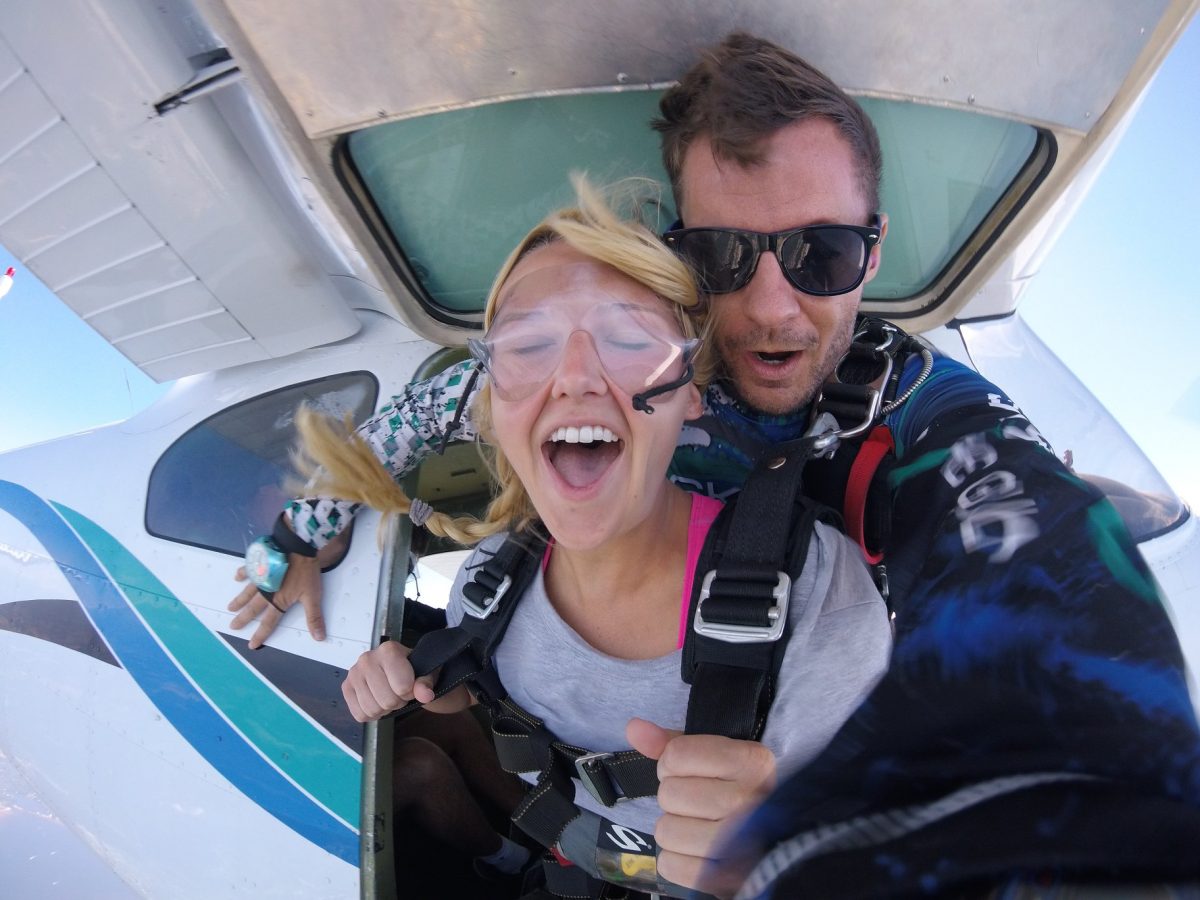 Girl jumping out of a plane at Skydive St Louis near the Gateway Arch