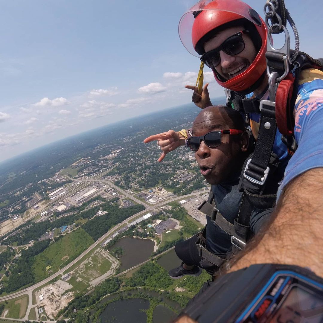 Man smiling under parachute during a tandem skydiving at Skydive STL in St Louis