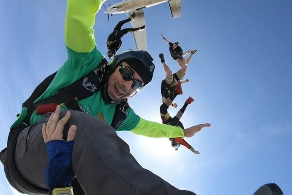 Jake Strain in freefall with other fun jumpers at Skydive STL